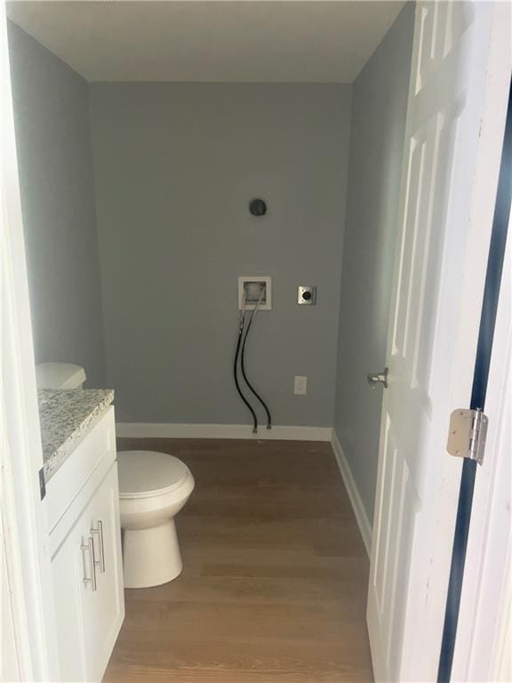 bathroom featuring vanity, hardwood / wood-style floors, and toilet