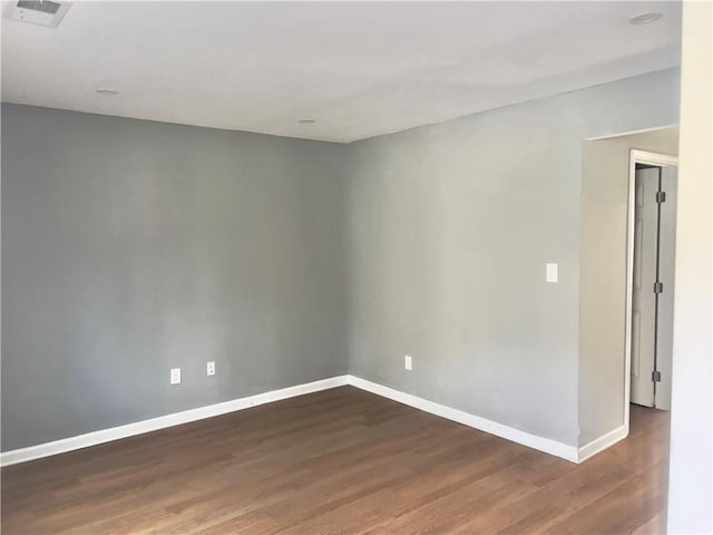 empty room featuring dark wood-type flooring