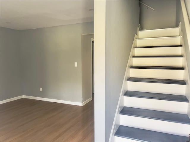 staircase with hardwood / wood-style floors