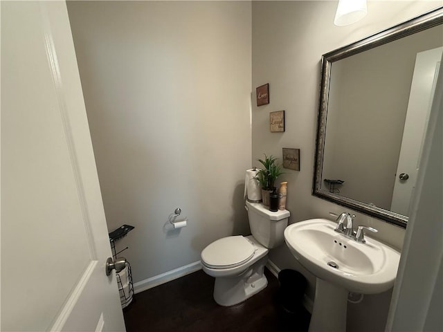 bathroom featuring sink, wood-type flooring, and toilet