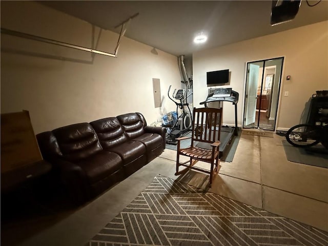 living room featuring electric panel and concrete flooring