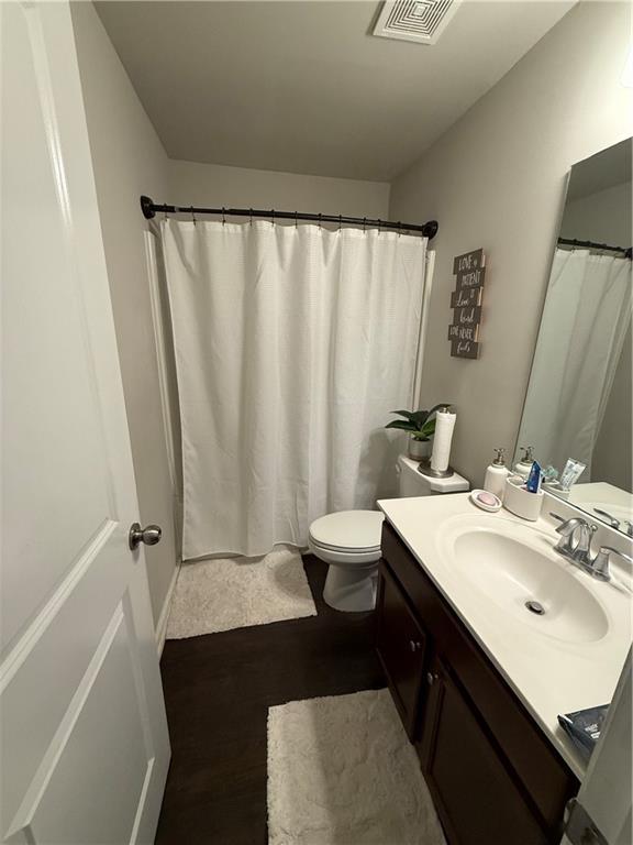 bathroom with vanity and toilet