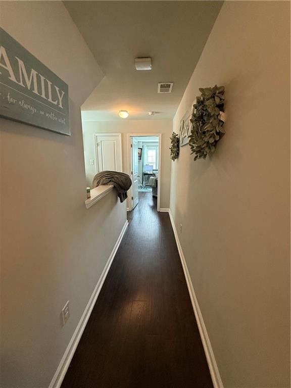 corridor featuring dark wood-type flooring