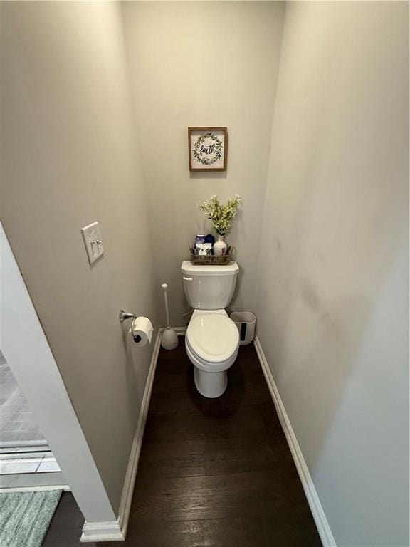 bathroom with toilet and hardwood / wood-style flooring