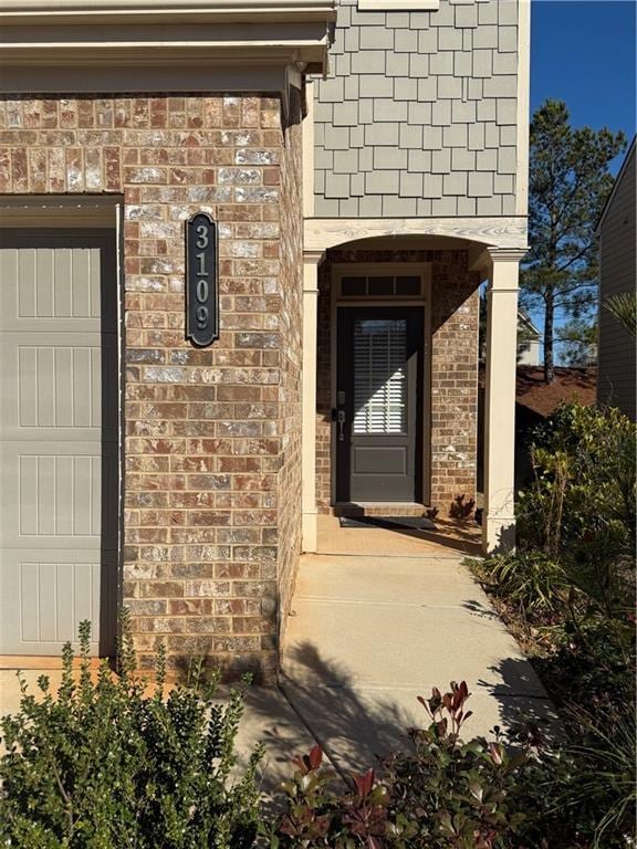 view of exterior entry featuring a garage