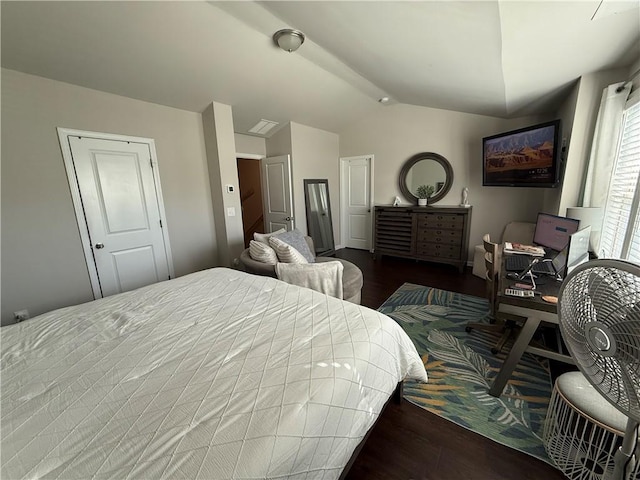 bedroom with vaulted ceiling and dark wood-type flooring