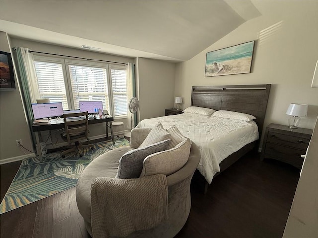 bedroom with dark hardwood / wood-style flooring and vaulted ceiling