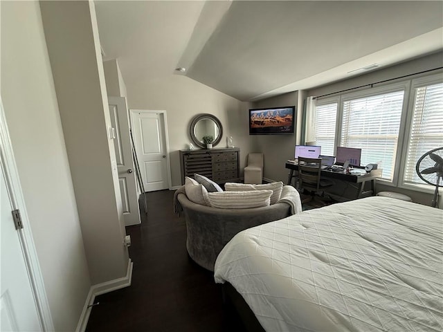 bedroom featuring dark hardwood / wood-style flooring and vaulted ceiling