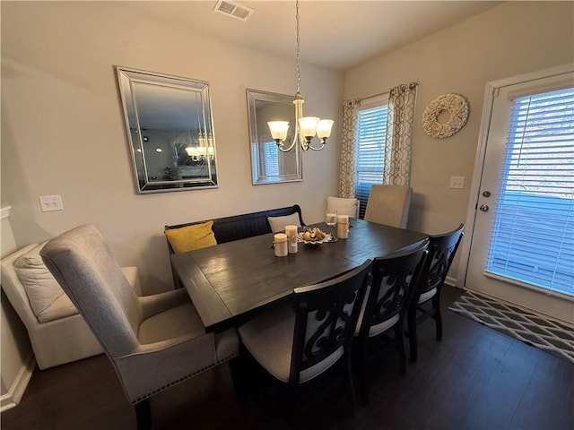 dining room featuring a notable chandelier and dark hardwood / wood-style flooring