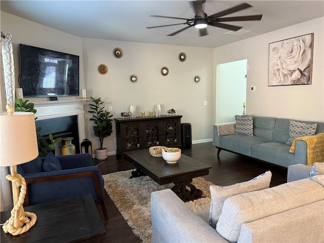 living room with ceiling fan and dark hardwood / wood-style floors