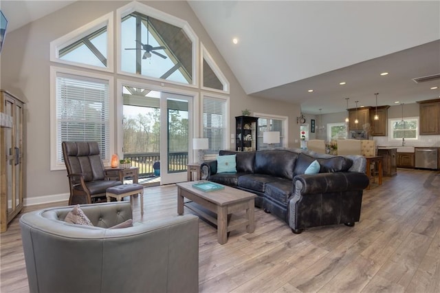 living area featuring a ceiling fan, visible vents, high vaulted ceiling, recessed lighting, and light wood-type flooring