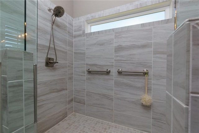 full bath with a tile shower