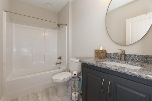 full bathroom featuring bathing tub / shower combination, toilet, and vanity