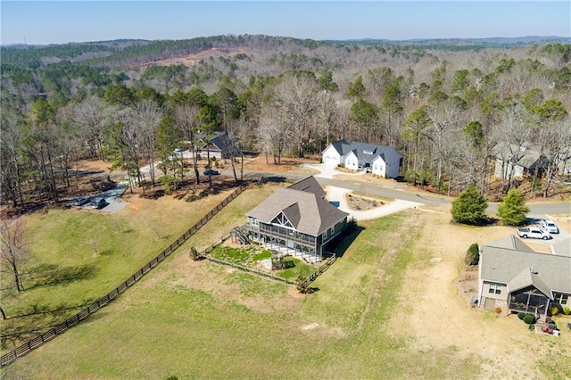 birds eye view of property featuring a rural view and a view of trees