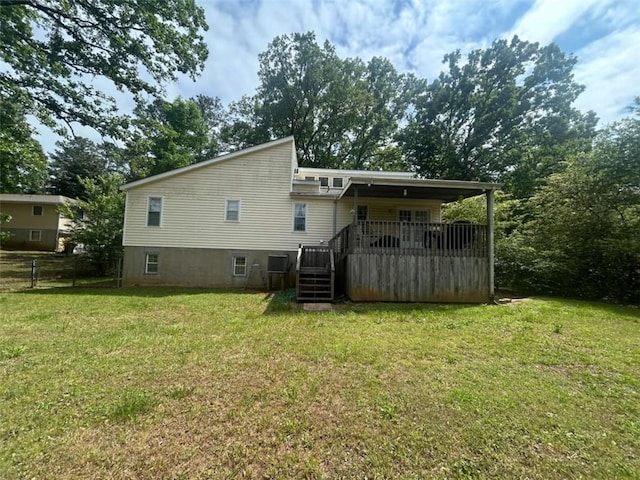rear view of property featuring a wooden deck and stairs