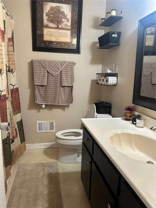 bathroom with toilet, vanity, tile patterned flooring, and a shower with shower curtain