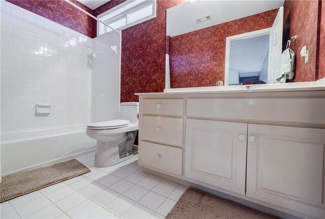 full bathroom featuring toilet, tile patterned flooring, tiled shower / bath, and vanity