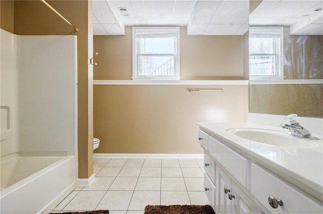 full bathroom with a paneled ceiling, tile patterned flooring, a healthy amount of sunlight, and vanity