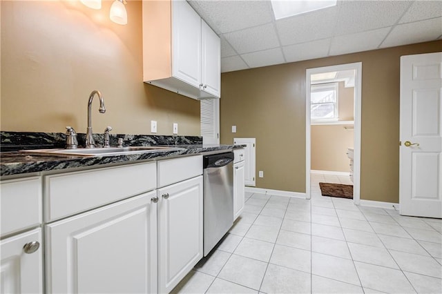 kitchen featuring sink, dark stone counters, white cabinetry, and stainless steel dishwasher