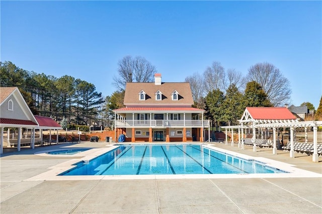 view of swimming pool with a patio and a pergola