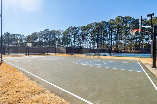 view of sport court featuring tennis court