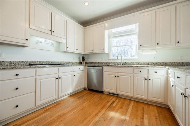 kitchen with dishwasher, white cabinets, gas cooktop, light hardwood / wood-style flooring, and light stone counters