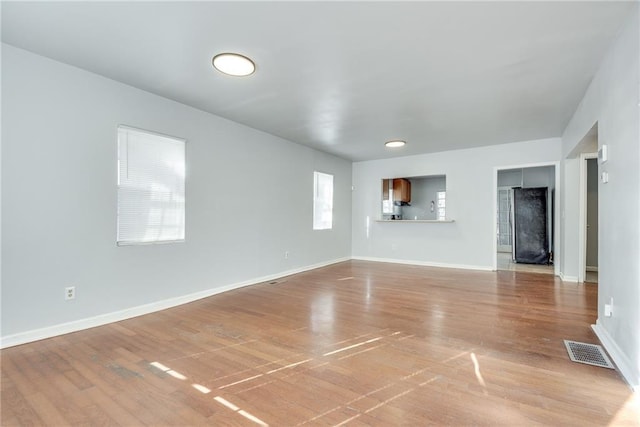 unfurnished living room with hardwood / wood-style flooring