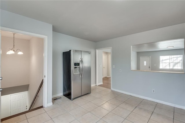 kitchen with pendant lighting, light tile patterned flooring, a chandelier, and stainless steel refrigerator with ice dispenser