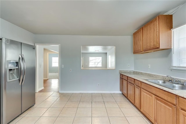 kitchen with sink, light tile patterned flooring, and stainless steel refrigerator with ice dispenser