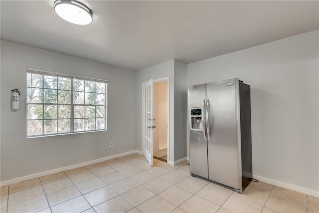 kitchen featuring stainless steel fridge and light tile patterned floors