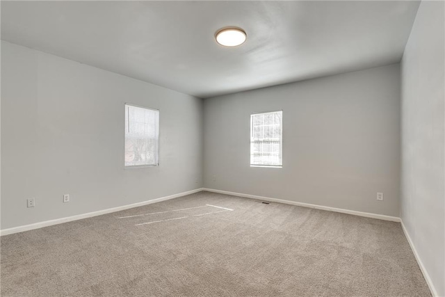 spare room featuring a healthy amount of sunlight and carpet