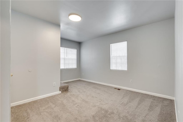 empty room featuring light carpet