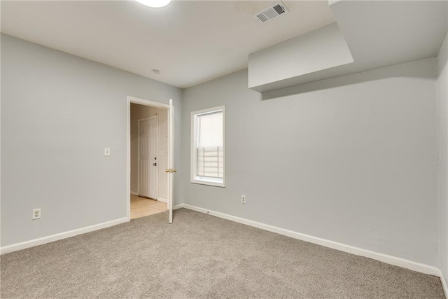 unfurnished room featuring light colored carpet