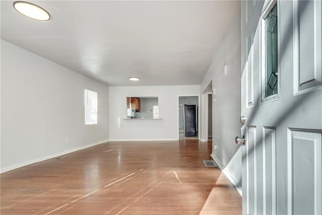 unfurnished living room featuring wood-type flooring