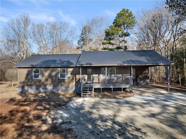 ranch-style house with covered porch and a carport