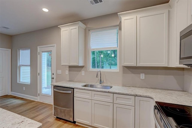 4230 Moore Rd, Conley, GA 30288 - kitchen with stainless steel appliances, light wood-style flooring, white cabinets, recessed lighting, and light stone countertops