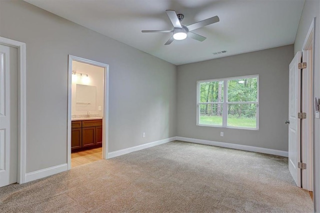4230 Moore Rd, Conley, GA 30288 - unfurnished bedroom with light carpet, connected bathroom, and a ceiling fan