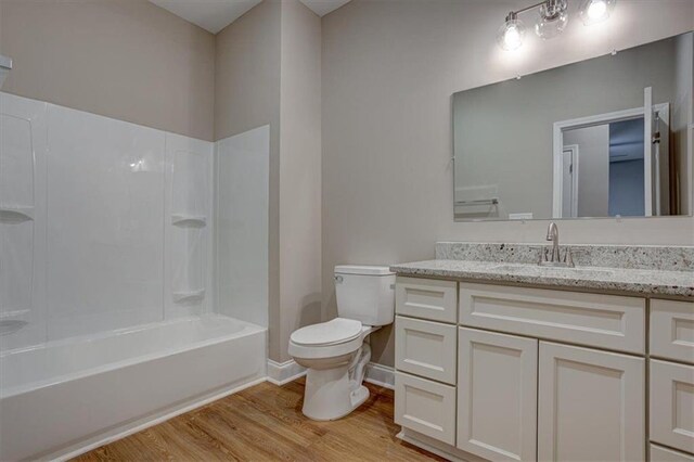4230 Moore Rd, Conley, GA 30288 - full bathroom featuring wood finished floors, vanity, and bathing tub / shower combination