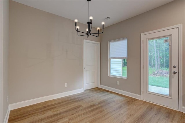 4230 Moore Rd, Conley, GA 30288 - unfurnished dining area featuring a chandelier and light wood finished floors