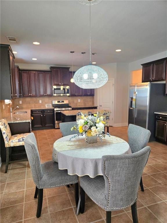 dining room featuring tile patterned flooring, visible vents, and recessed lighting