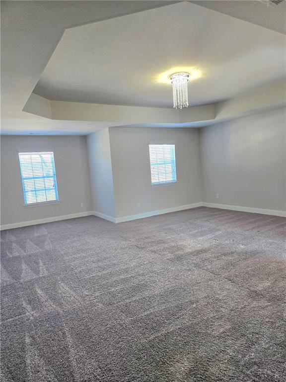 empty room with carpet, a wealth of natural light, and baseboards