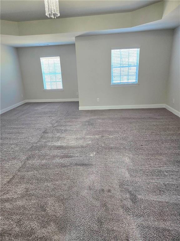 carpeted empty room with baseboards