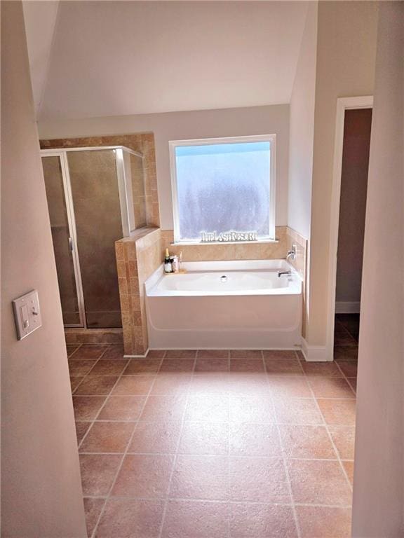 full bath with a stall shower and a garden tub