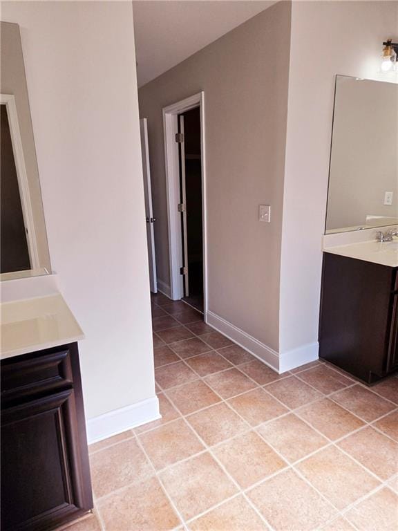 interior space featuring baseboards and light tile patterned floors