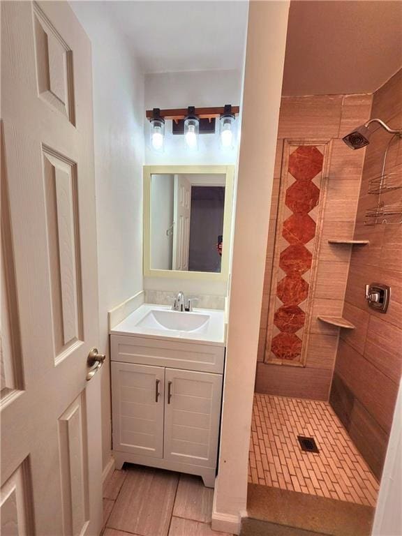 bathroom featuring vanity and a tile shower