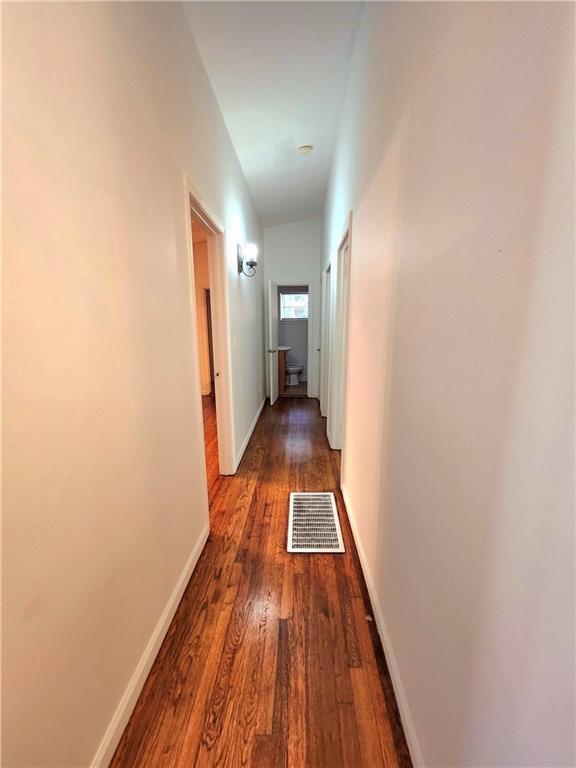 corridor featuring dark hardwood / wood-style flooring