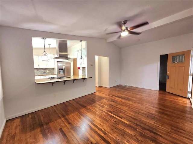 unfurnished living room with vaulted ceiling, dark hardwood / wood-style floors, and ceiling fan