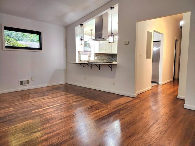 unfurnished living room with dark wood-type flooring