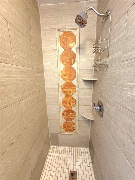 bathroom with a tile shower