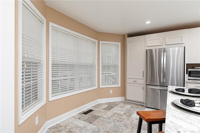 kitchen with stainless steel appliances, white cabinets, light countertops, baseboards, and recessed lighting
